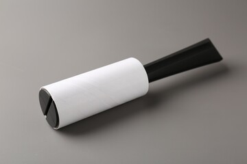 One lint roller on grey background, closeup