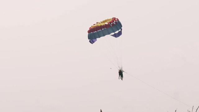 Vietnam Travel 4K Tourist Parasailing Over a Pristine In Phu Quoc
The parasailer high above the water, showcasing the ideal weather and stunning scenery of this Vietnamese island.