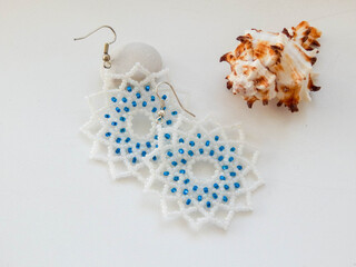 White earrings and sea shell