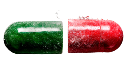 two pills, one green and the other red, with powder