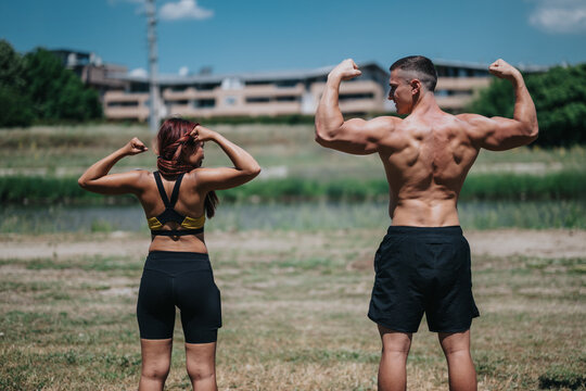 Two athletic people showcase their muscular physiques by flexing back and arm muscles outdoors in clear daylight. They demonstrate fitness passion and dedication in a natural environment. - Powered by Adobe