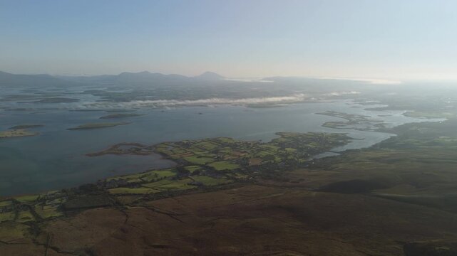 Breathtaking 4K aerial video of flying above scenic Atlantic Coast at Clew Bay with scenic coastline and islands at dawn, Murrisk, Westport, Mayo, Ireland