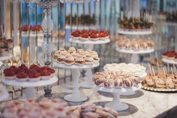 Delightful sweets displayed on elegant stands in a vibrant pastry shop during a cheerful afternoon