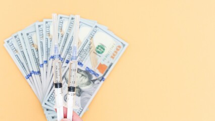 Concept of Healthcare Costs Syringes and US Currency Symbolize Medical Expenses.