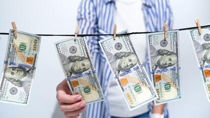 Money Laundering Concept Hundred Dollar Bills Drying on a Clothesline. Financial Crime