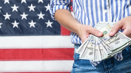 Financial Prosperity in America Person Holding US Currency with American Flag Backdrop
