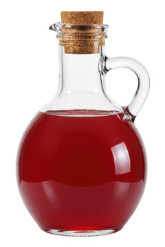 Glass carafe filled with red liquid and cork stopper sits on black background.