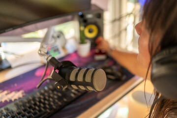 Woman creating podcast content recording in home studio