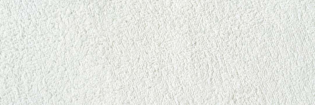 Close-up texture of white soft terry fabric creating cozy and comfortable background.
