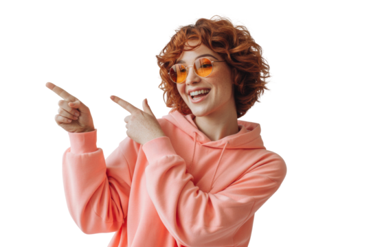 Young woman with curly red hair wearing a pink hoodie pointing to the side - Powered by Adobe