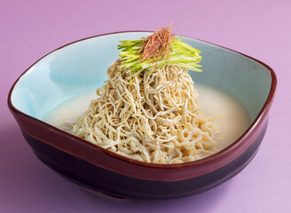 Korean soy milk noodle soup, stewed shredded dried tofu sheet, chicken, ham a light and healthy meal perfect for a modern restaurant or a delicious at-home lunch