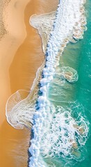 High-angle view of a beach shoreline with intricate patterns of waves and foam.