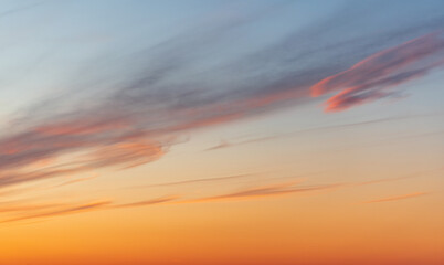 A tranquil sunset fills the sky with warm orange hues near the horizon