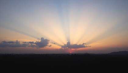 Radiant evening sky over jungle with soft sunset