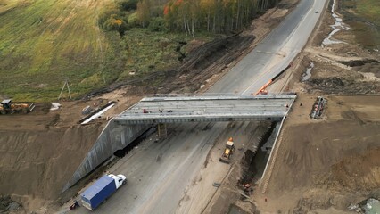 Bridge construction progress: workers installing precast concrete beams. Clip