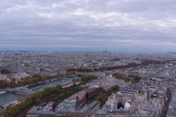 Naklejka premium Paris illuminated at nightfall, seen from the top of the Eiffel Tower, with illuminated buildings and streets