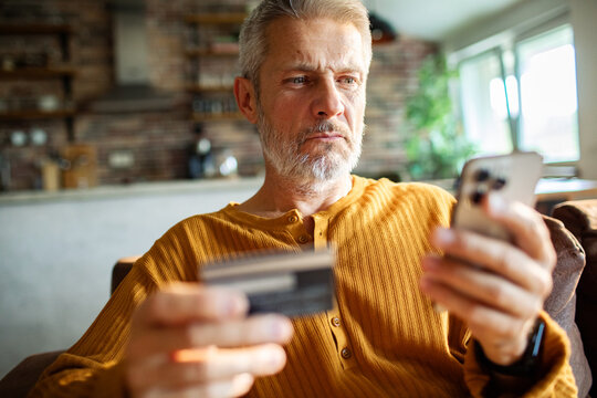 Mature man shopping online at home