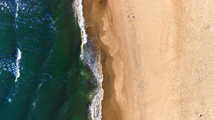 Aerial beach landscape with natural sea patterns and soft light tones.