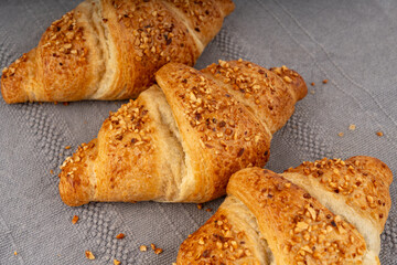 Delicious croissant with nut crumbs, sweet French bakery