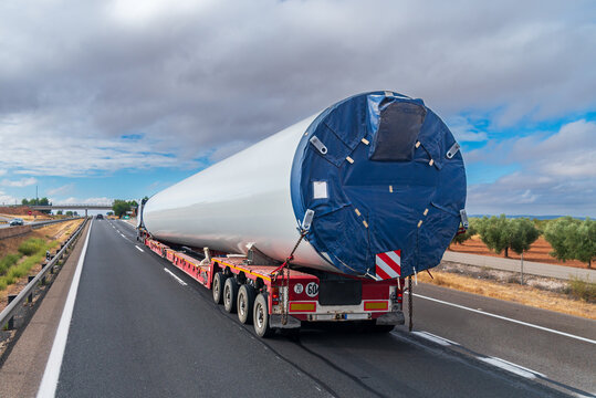 Special transport truck hauling a wind turbine tower segment, rear perspective