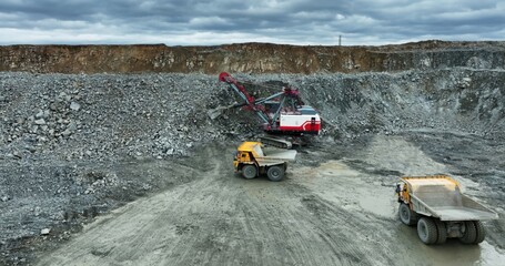 Excavator loading dump truck in quarry. Stock clip