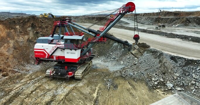 Excavator loading dump truck in open pit mine. Stock clip