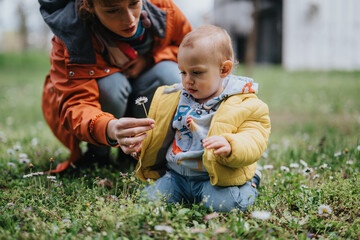 A parent shares quality time guiding their toddler in a scenic meadow. The image captures an...