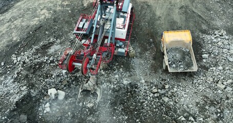 Excavator loading dump truck at quarry. Stock clip