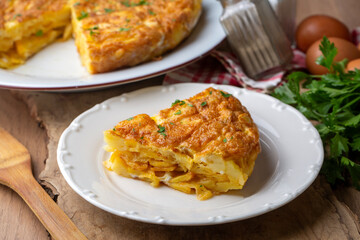 Spanish omelette with potatoes, typical spanish cuisine on gray concrete floor. Tortilla Espanola. Turkish name; Yumurtali patates
