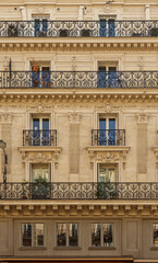 Historic Haussmannian building in Paris showcasing elegant balconies, decorative stone facade, and...