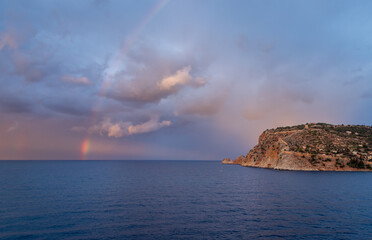 Golden sunset light illuminates Alanya Castle and the ancient fortress walls above the Mediterranean Sea in Alanya Turkey, showcasing historic architecture and scenic coastal beauty