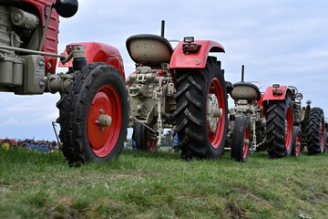 The historic tractors on a meadow agricultural machinery