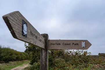 Close up of the wooden Norfolk Coast Path sign in the sand dunes in Winterton, Norfolk