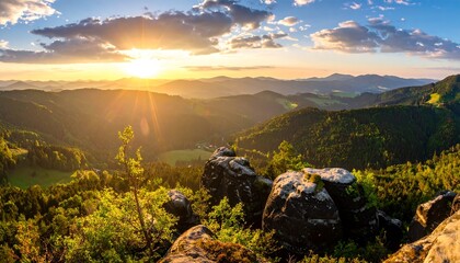A sweeping vista of rolling mountain ranges, bathed in golden sunlight as the sun sets, casting a warm glow over the forested valleys below