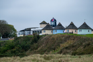 Colourful round houses in the sand dunes used as holiday lets on the Norfolk coast
