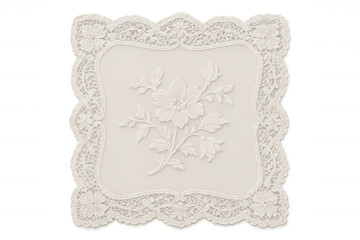 Decorative white lace doily with elegant floral embroidery pattern on textile creating a vintage craft