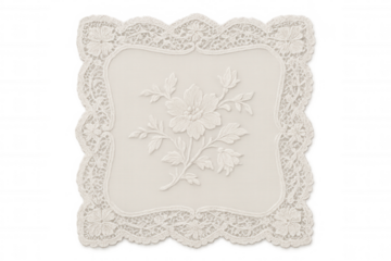 Decorative white lace doily with elegant floral embroidery pattern on textile creating a vintage craft