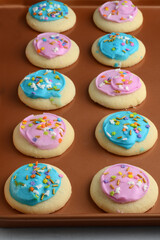 rows of colorful sugar cookies on baking tray