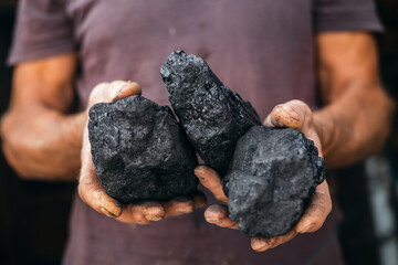 Coal in miner holds. Concept industry mining