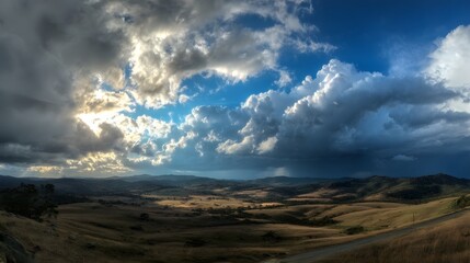 Dramatic sky over a rural landscape with clouds and sun rays breaking through