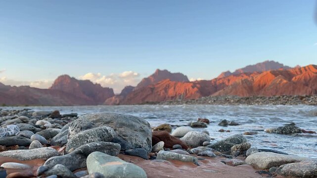 time-lapse of sunset over mountains and flowing river in tianshan mysterious grand canyon, xinjiang, china