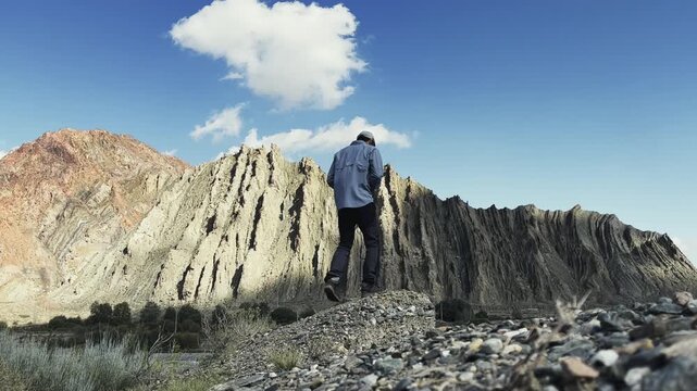 rear view of asian photographer taking a landscape photo outdoors in xinjiang, china