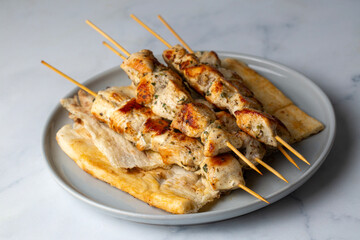 Greek grilled chicken skewers - chicken souvlaki served with lemon