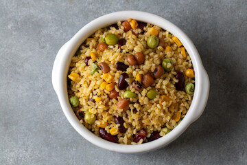 Bulgur pilaf with legumes; with peas, beans and corn kernels.