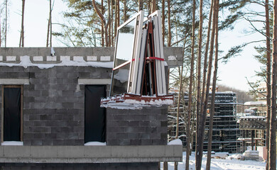 A private house under construction in the winter forest