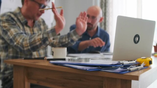 contract negotiation tension, white partners review contract carefully, focused professionals negotiate budget with contract review, tense professional exchange during budget negotiations