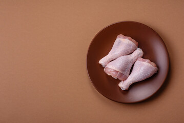 Raw chicken legs, poultry meat on the bone for barbecue. Chicken legs as a food background