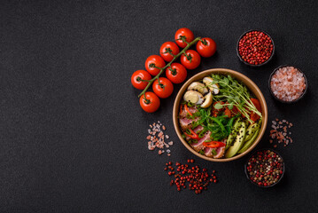 Seared tuna tataki in a bowl with sesame seeds, rice, and vegetables. Tuna tataki