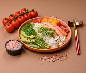 A prawn or shrimp bowl with rice, tomatoes, sauce, and vegetables, Asian food. Prawn or shrimp