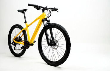 Fototapeta premium Bright yellow mountain bike stands isolated on clean white background. New bicycle features knobby black tires, sturdy handlebars, comfortable, disc brakes. Perfect for outdoor adventures, rough